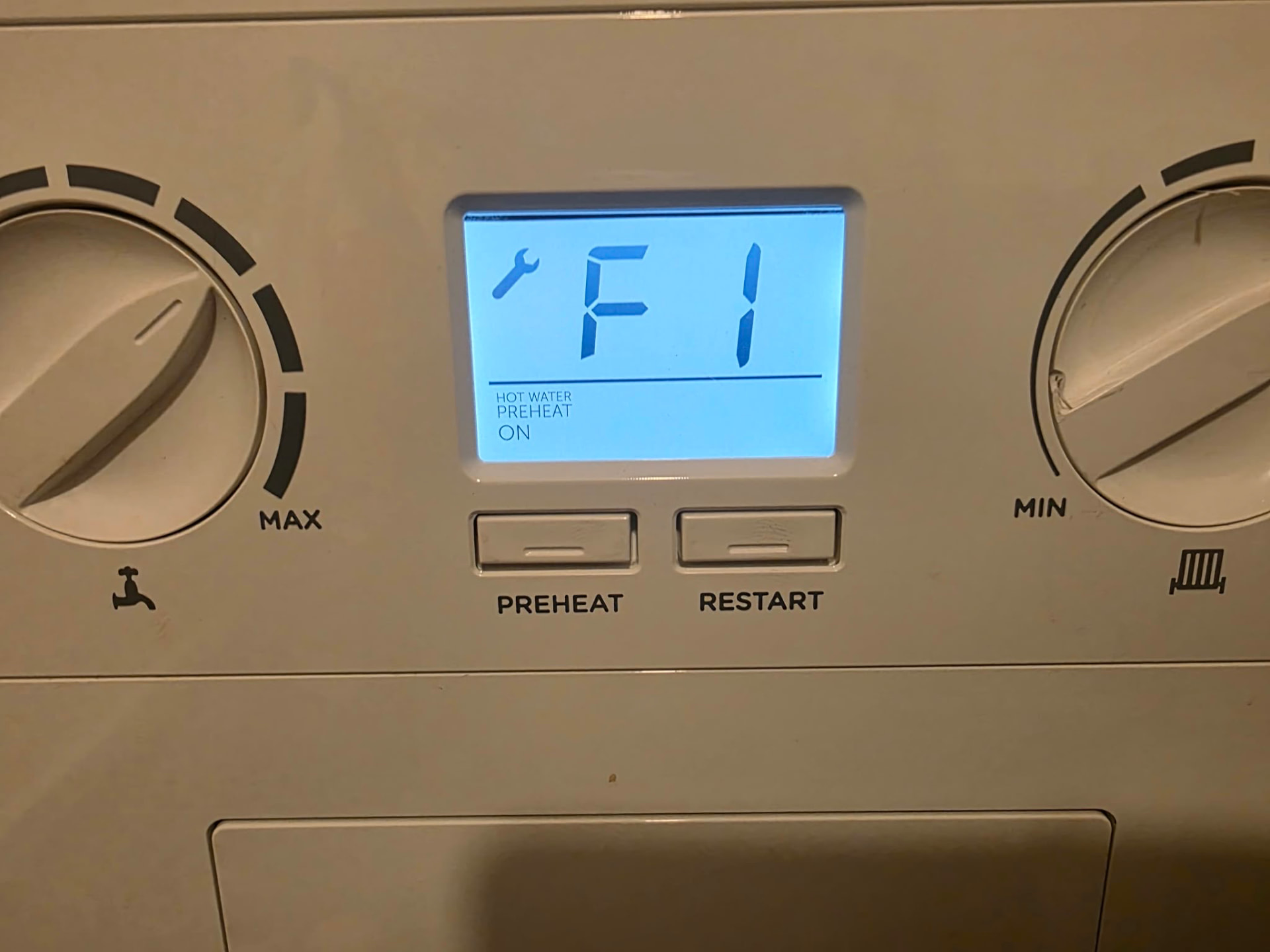 Boiler control panel displaying an F1 fault code Boiler control panel displaying an F1 fault code